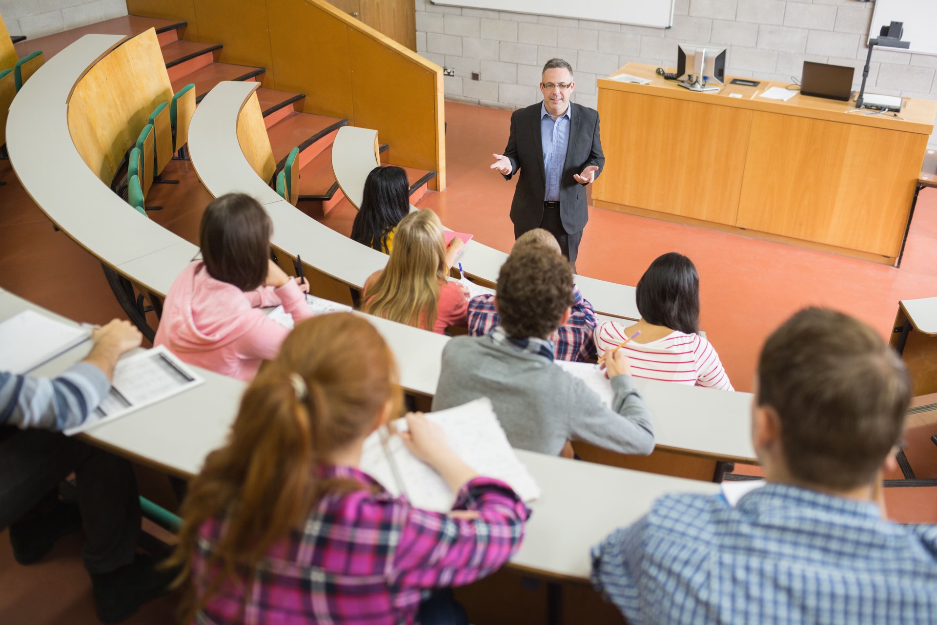 Elegant teacher with students at the lecture hall